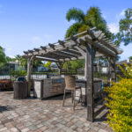 Poolside cabana with grills and bar height seating