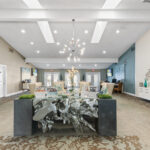 Large room with modern, ornate reception desk and lounge seating