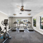 fitness center with treadmills and a stationary bike